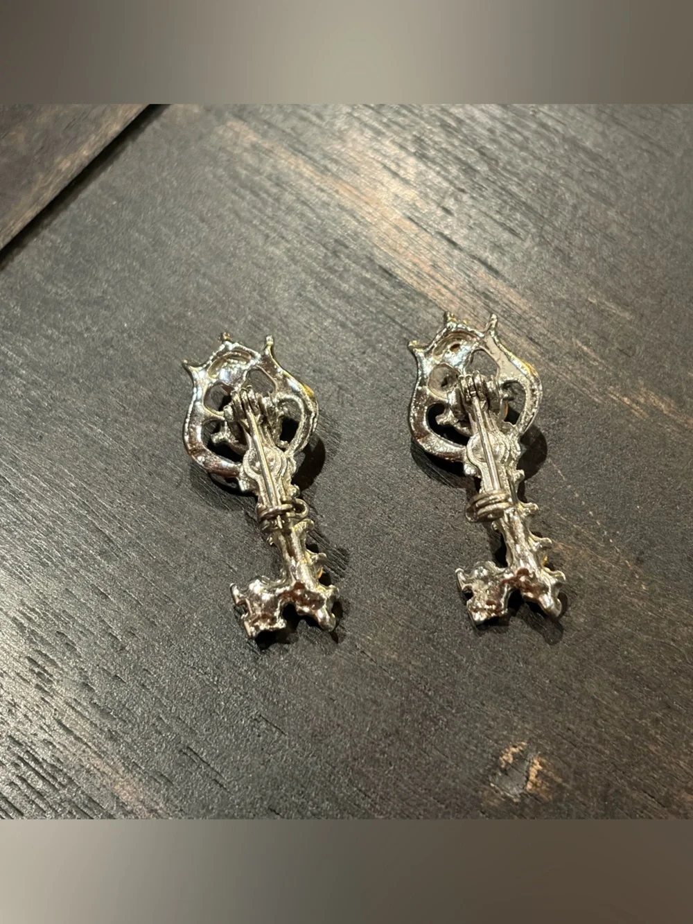 Silver and blue twin key brooches